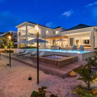 7.8 b.e. grace bay beachfront 5bd night view