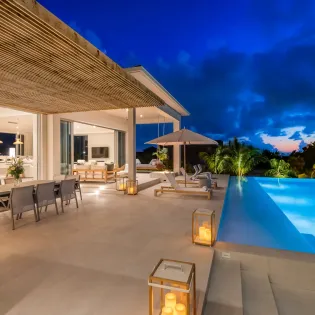 7.9 b.e. grace bay beachfront 5bd night view