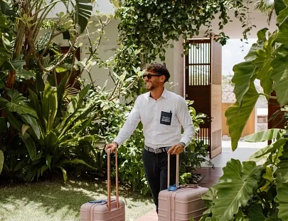 concierge service with a male holding two suitcases