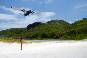 Watch the planes take off from the beach at St. Barths