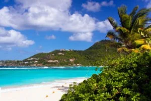 A short path leads to pristine white sand and blue water.