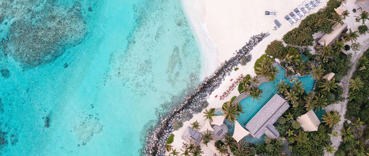 ?image=necker island-main-beach-crocodile-pavilion-aerial-1 desktop