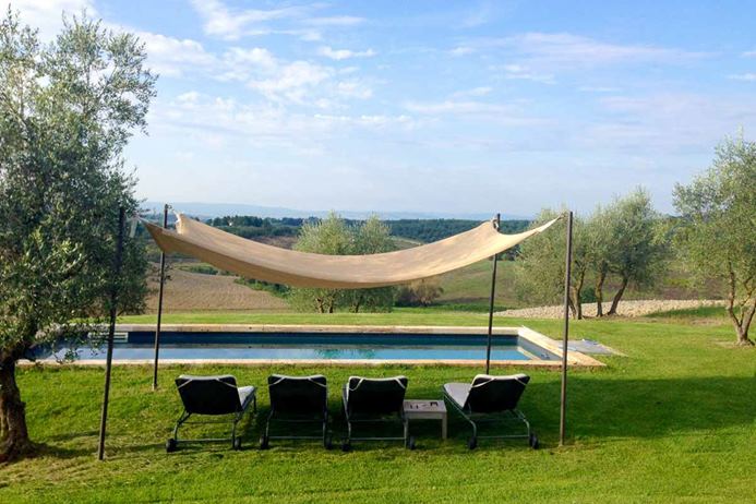 Villa in Tuscany, Italy with pool overlooking hillside vista.
