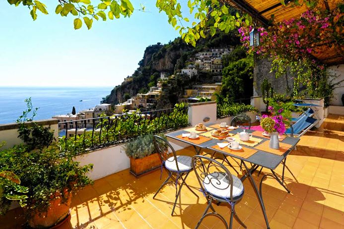 Waterfront villa on the Amalfi Coast of Italy with large deck overlooking the sea.