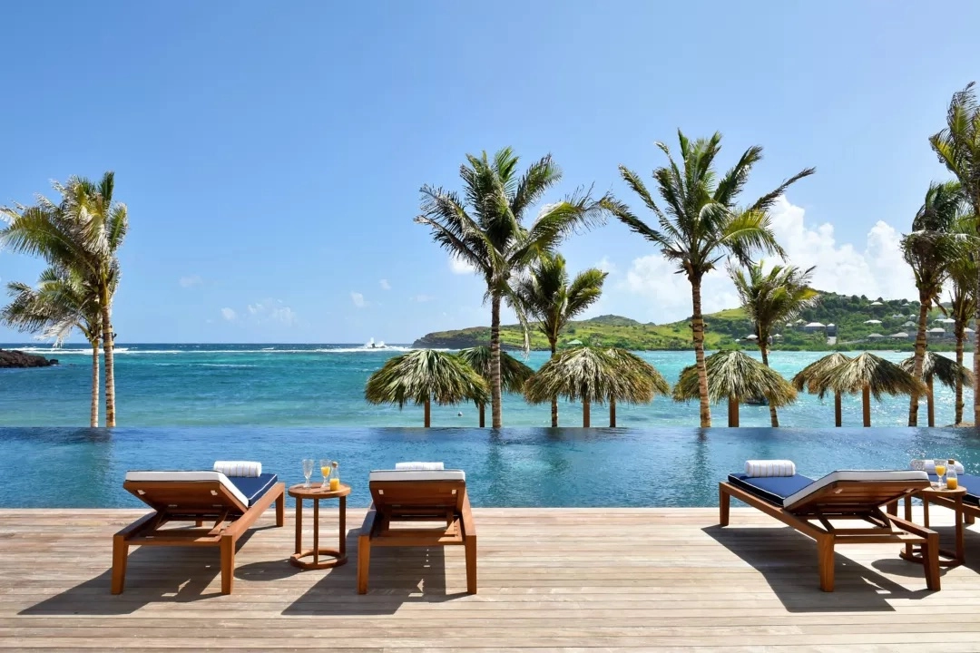 Relax by the pool at Rosewood Le Guanahani